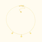 Delicate gold necklace with three star-shaped charms.