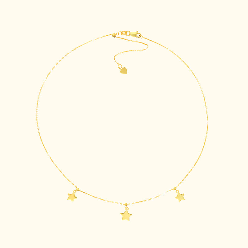 Delicate gold necklace with three star-shaped charms.