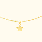 Gold necklace featuring a small star pendant on a delicate chain.