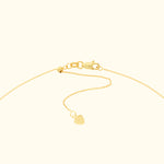 Delicate gold chain necklace with a small heart pendant.