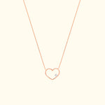 Rose gold heart necklace with a small diamond accent.