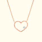 Rose gold heart necklace featuring a small diamond accent.