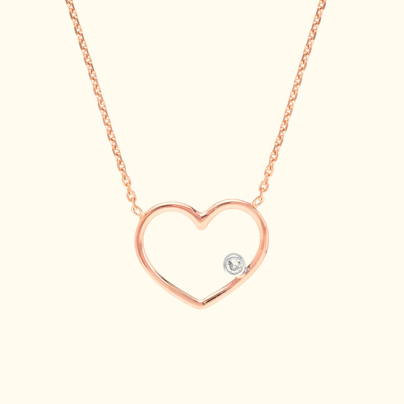 Rose gold heart necklace featuring a small diamond accent.