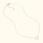 Delicate rose gold heart necklace with a small diamond accent.