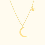 Gold necklace featuring a crescent moon and a small star charm.