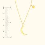 Gold pendant necklace featuring a crescent moon and a small star charm.