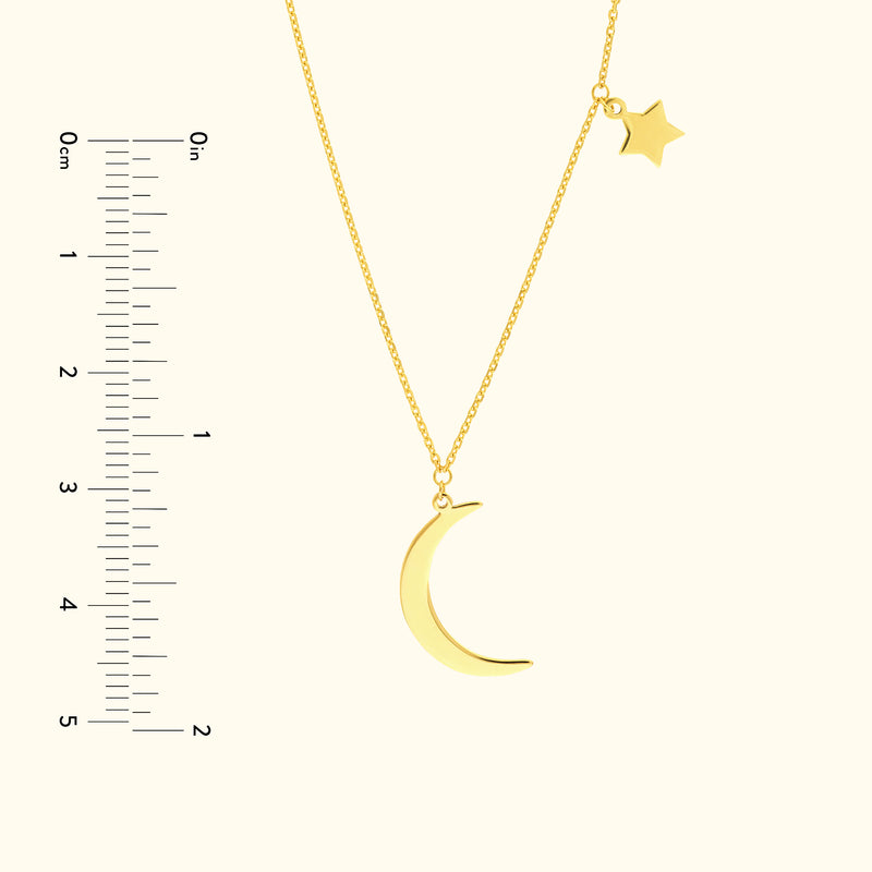 Gold pendant necklace featuring a crescent moon and a small star charm.