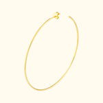 Simple gold hoop earring with a floral accent at the closure.