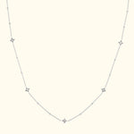 Delicate silver necklace with alternating diamond-like stars on a fine chain.