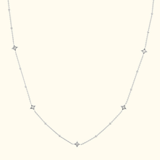 Delicate silver necklace with alternating diamond-like stars on a fine chain.