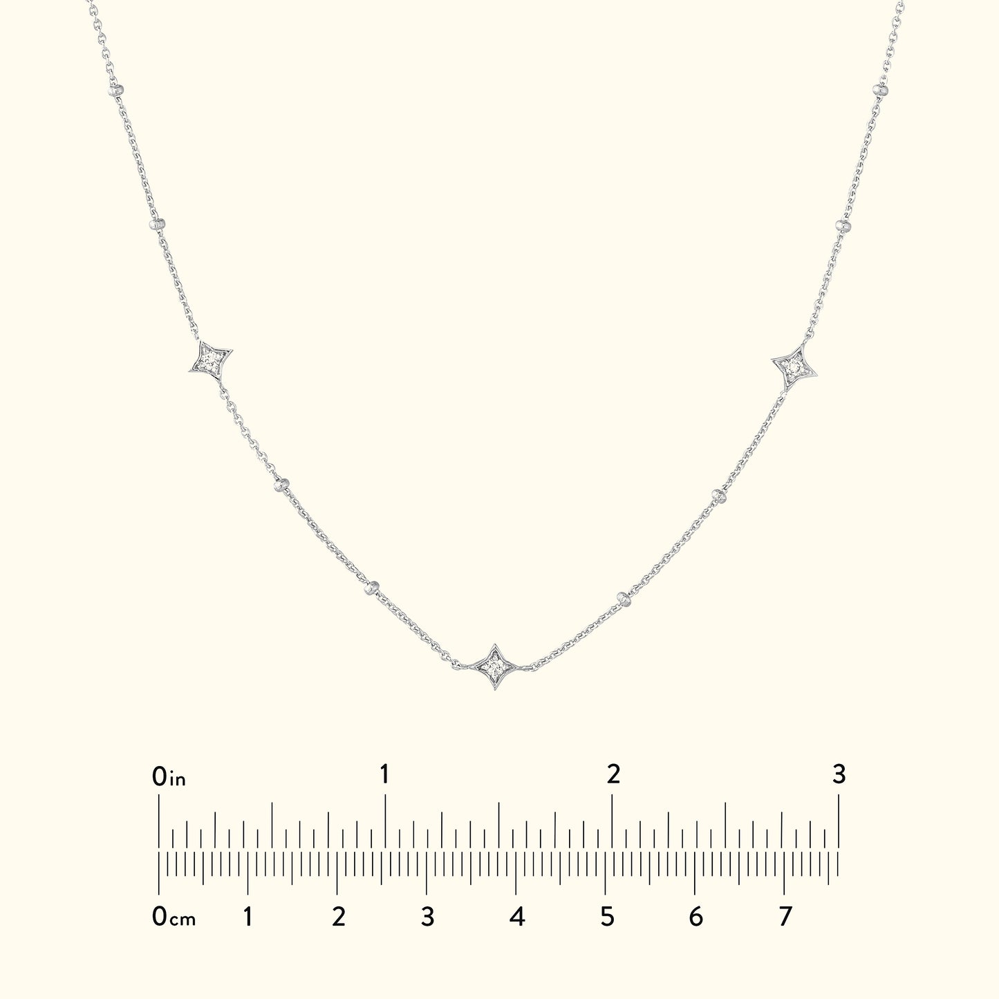 Delicate silver necklace with diamond accents set in a curved design.