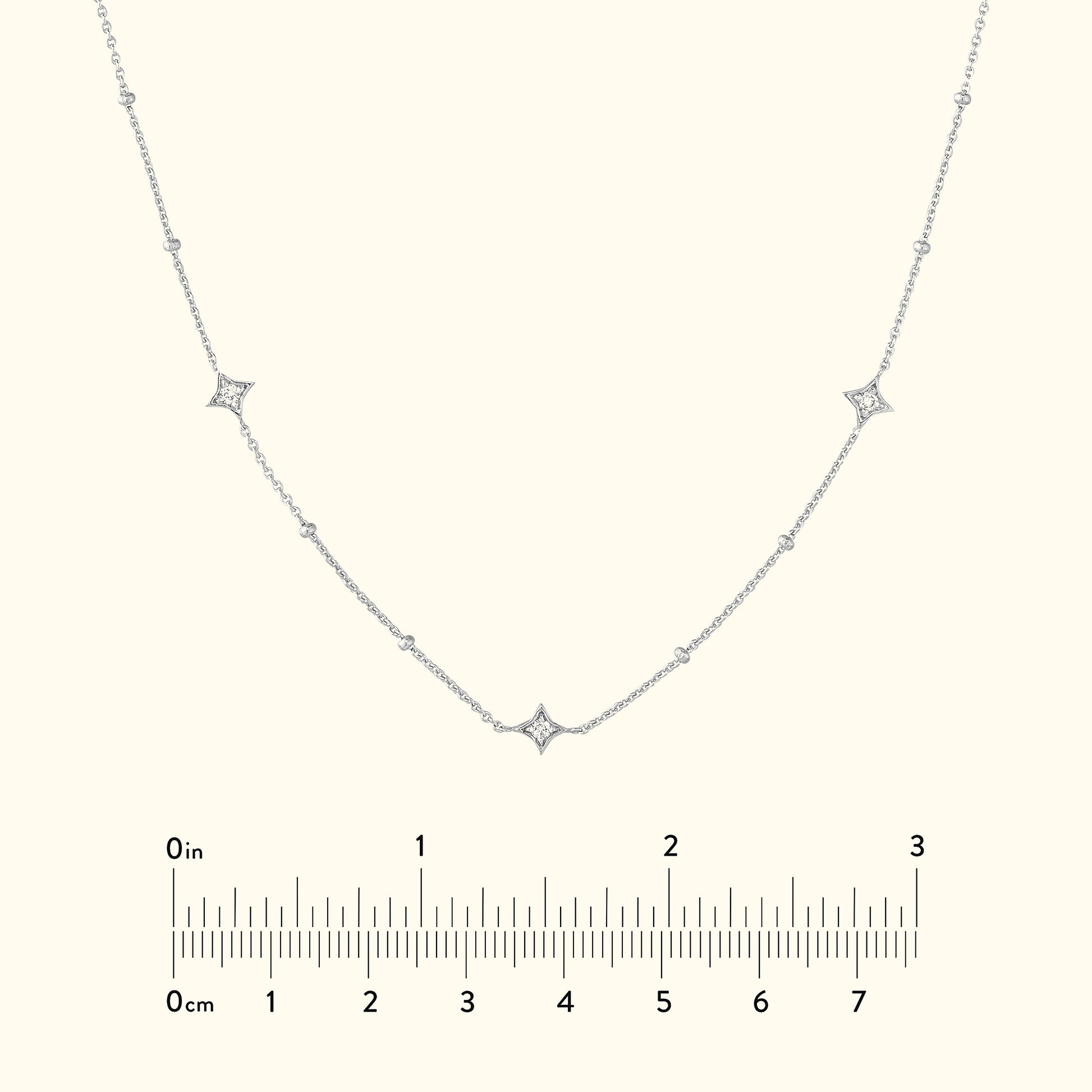 Delicate silver necklace with diamond accents set in a curved design.