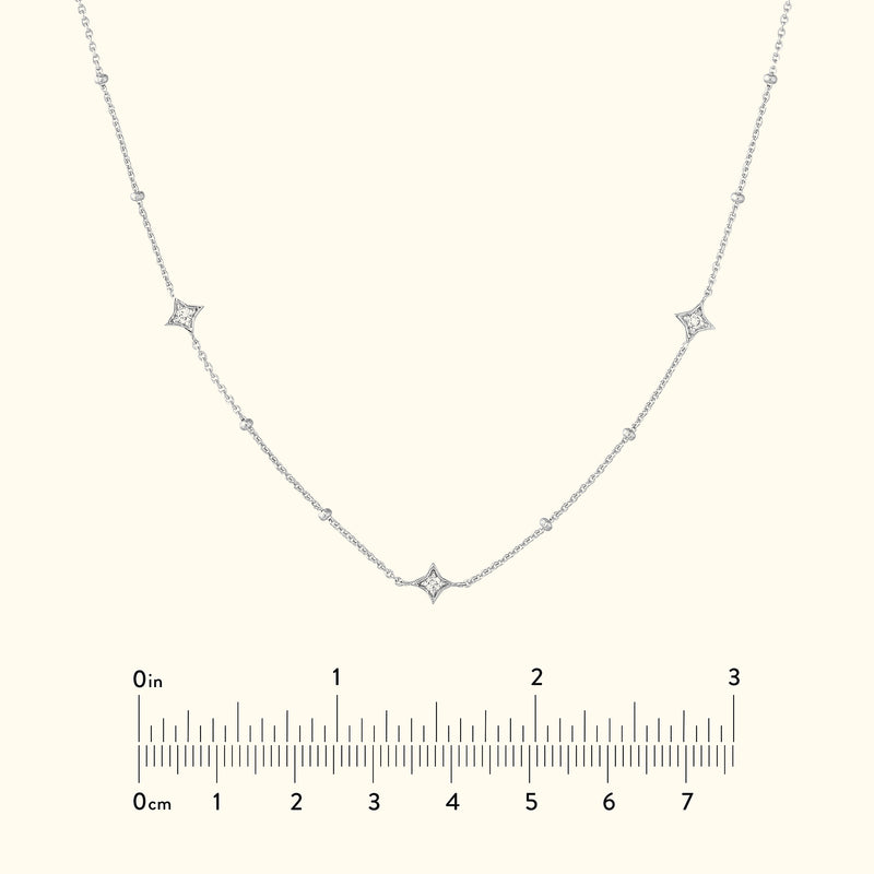 Delicate silver necklace with diamond accents set in a curved design.