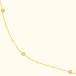 Delicate gold necklace with sparkling diamond accents.