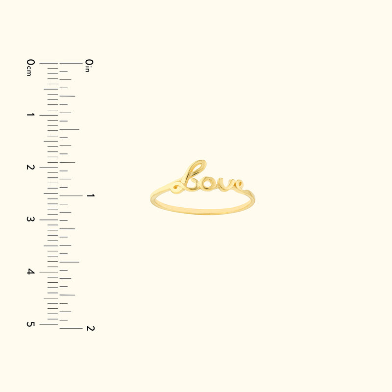Gold ring featuring the word "love" in cursive script, displayed against a light background.