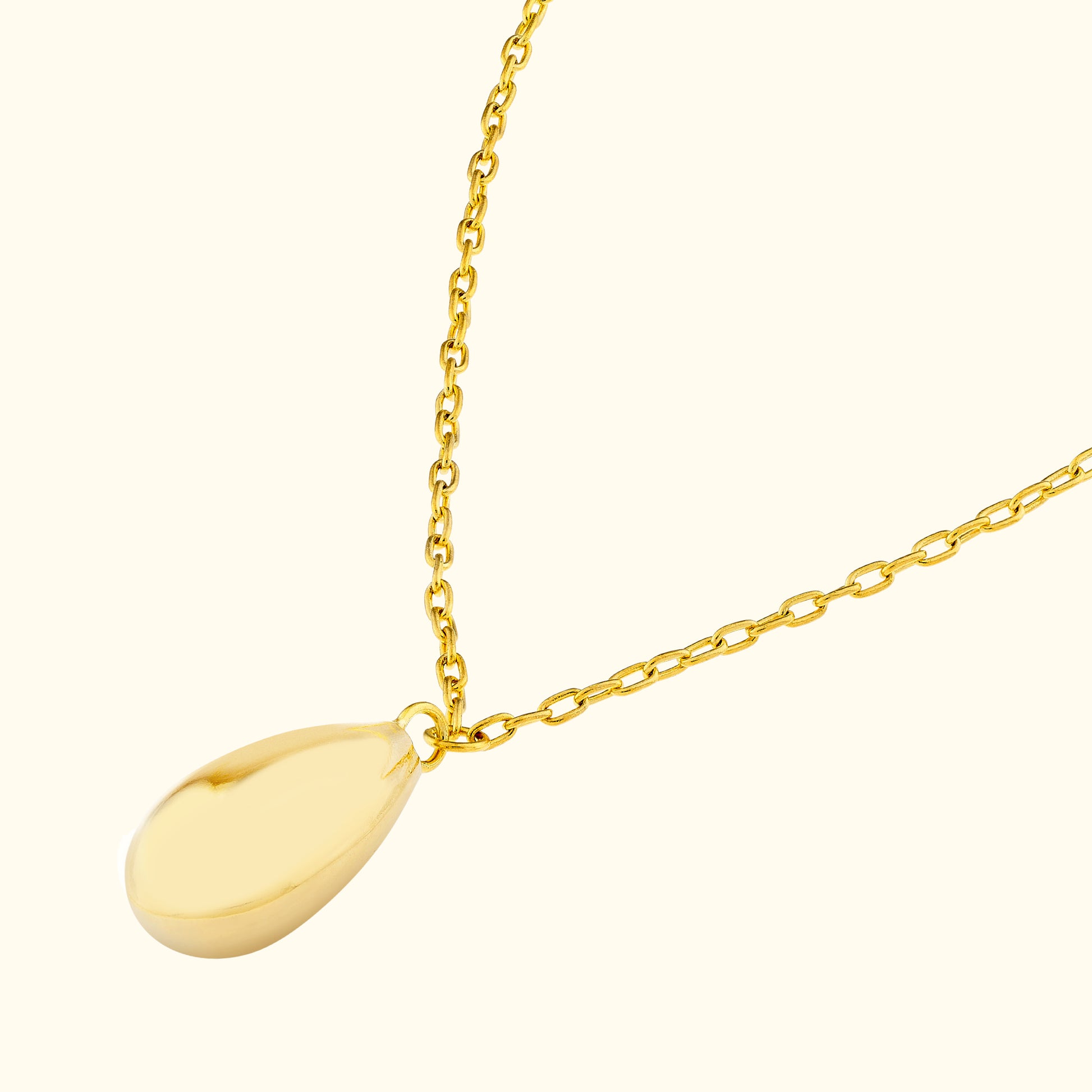 Gold necklace with a smooth, teardrop-shaped pendant on a delicate chain.