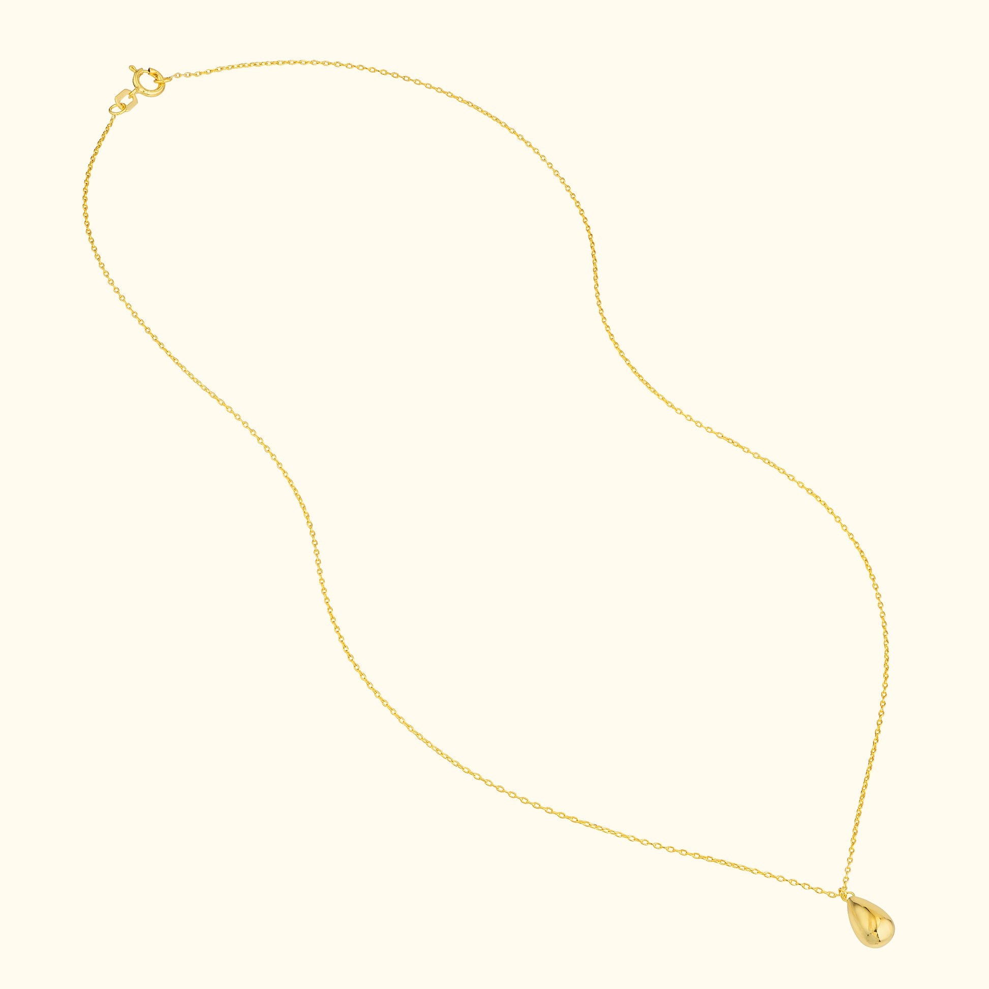 Delicate gold chain necklace with a teardrop-shaped pendant.