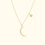 Gold necklace with a crescent moon and a star, adorned with sparkling gems.