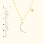 Gold necklace featuring a crescent moon and star, adorned with sparkling gems.