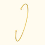 Simple gold cuff bracelet with rounded ends, elegantly minimalistic design.