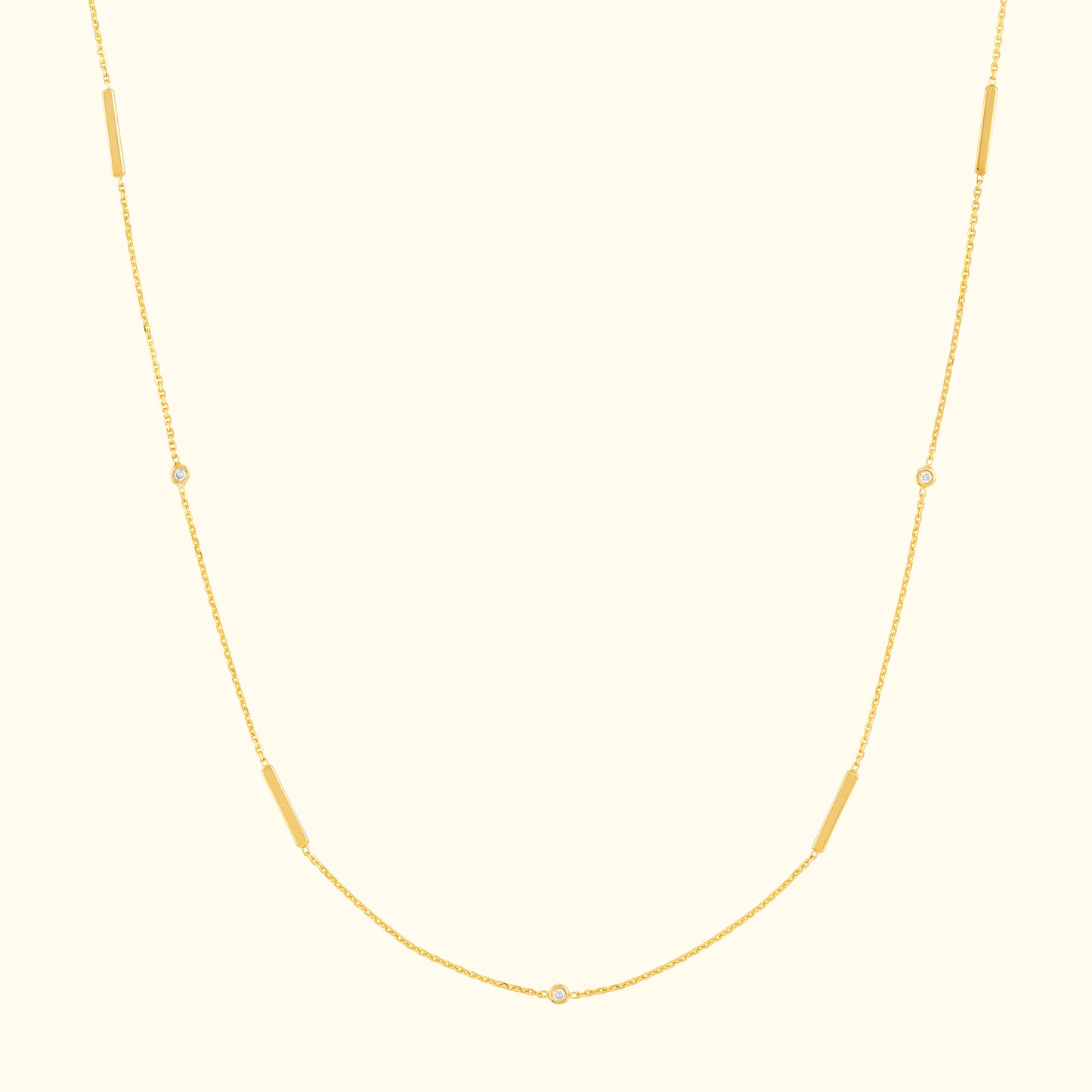 Delicate gold necklace with elongated and circular links.