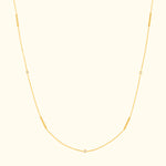 Delicate gold necklace with elongated and circular links.