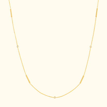 Delicate gold necklace with elongated and circular links.