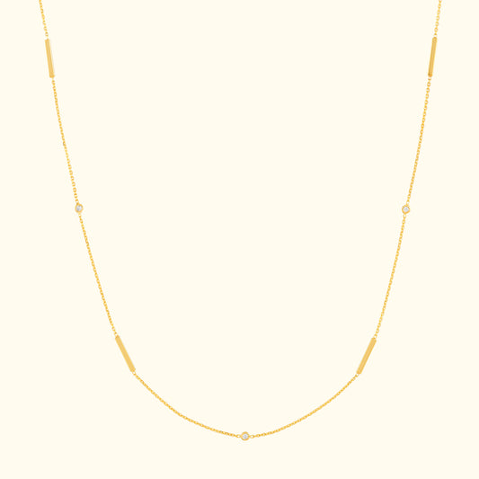 Delicate gold necklace with elongated and circular links.