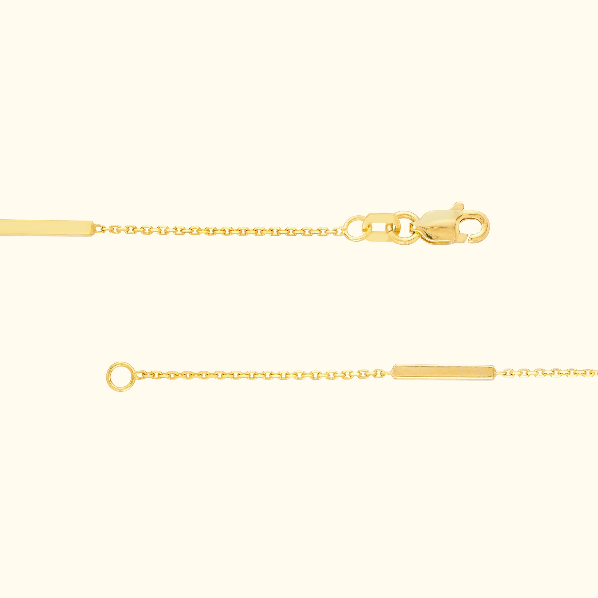 Delicate gold chain bracelet with a rectangular tag and lobster clasp.