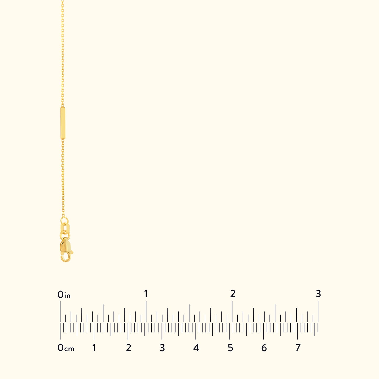 Delicate gold chain necklace with a lobster clasp and measurement scale below.