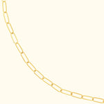 Gold link chain necklace with elongated oval shapes against a light background.