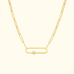 Gold chain necklace featuring an oval link and a central diamond accent.