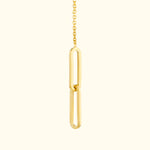 Gold pendant necklace featuring an abstract link design on a delicate chain.