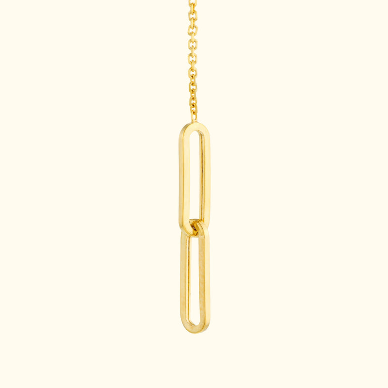 Gold pendant necklace featuring an abstract link design on a delicate chain.