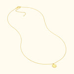 Delicate gold necklace with a sun-shaped pendant, suspended on a thin chain.