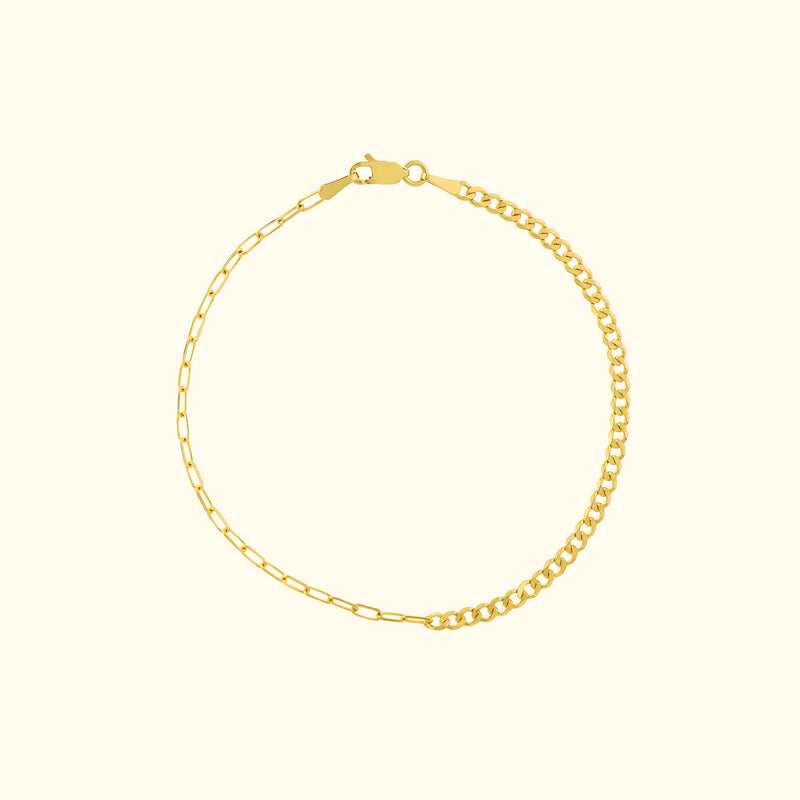 Gold chain bracelet with a mix of link styles and a lobster clasp.