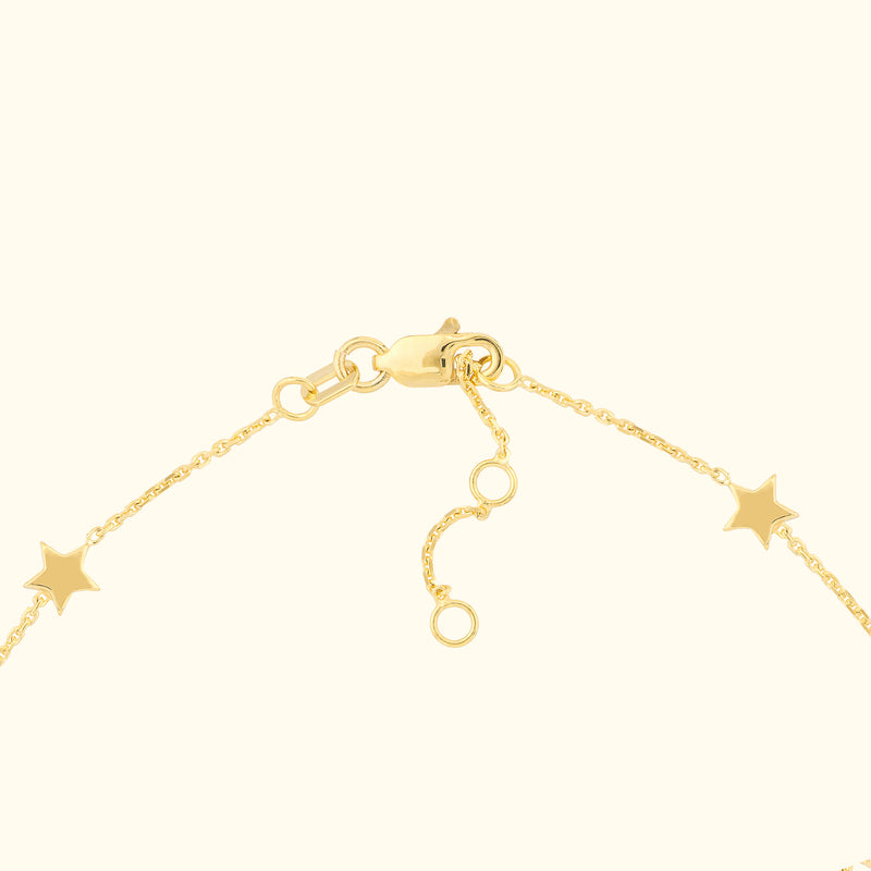 Gold bracelet with star charms and a clasp closure.