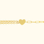 Golden bracelet with a heart-shaped pendant and two chain links.