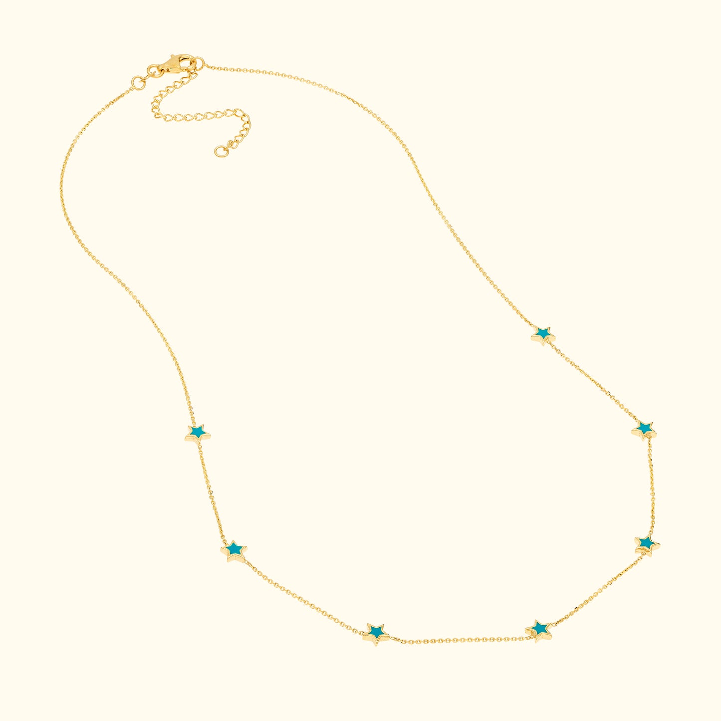 Gold necklace featuring star-shaped turquoise accents evenly spaced along the chain.