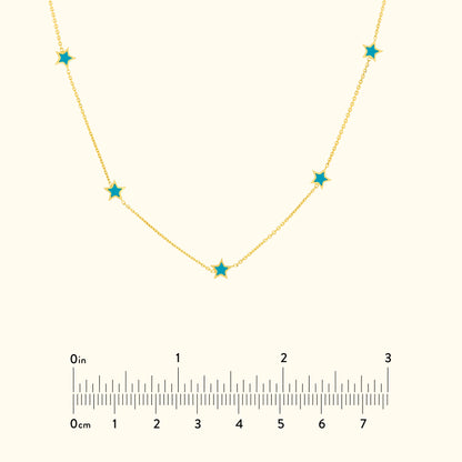 Gold chain necklace with turquoise star-shaped pendants.