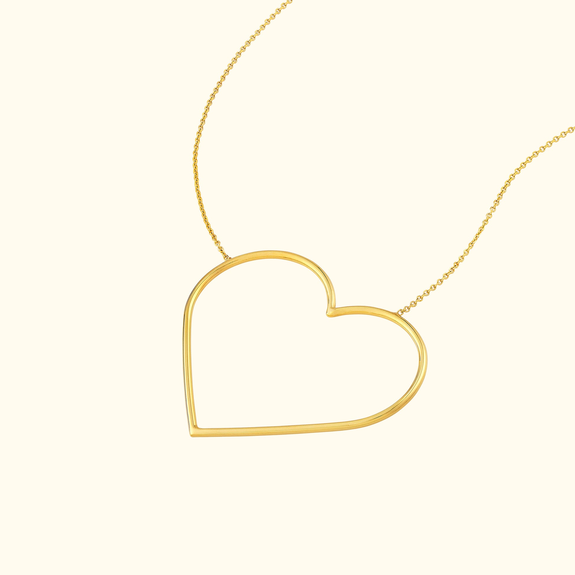 Gold heart-shaped pendant necklace on a fine chain.