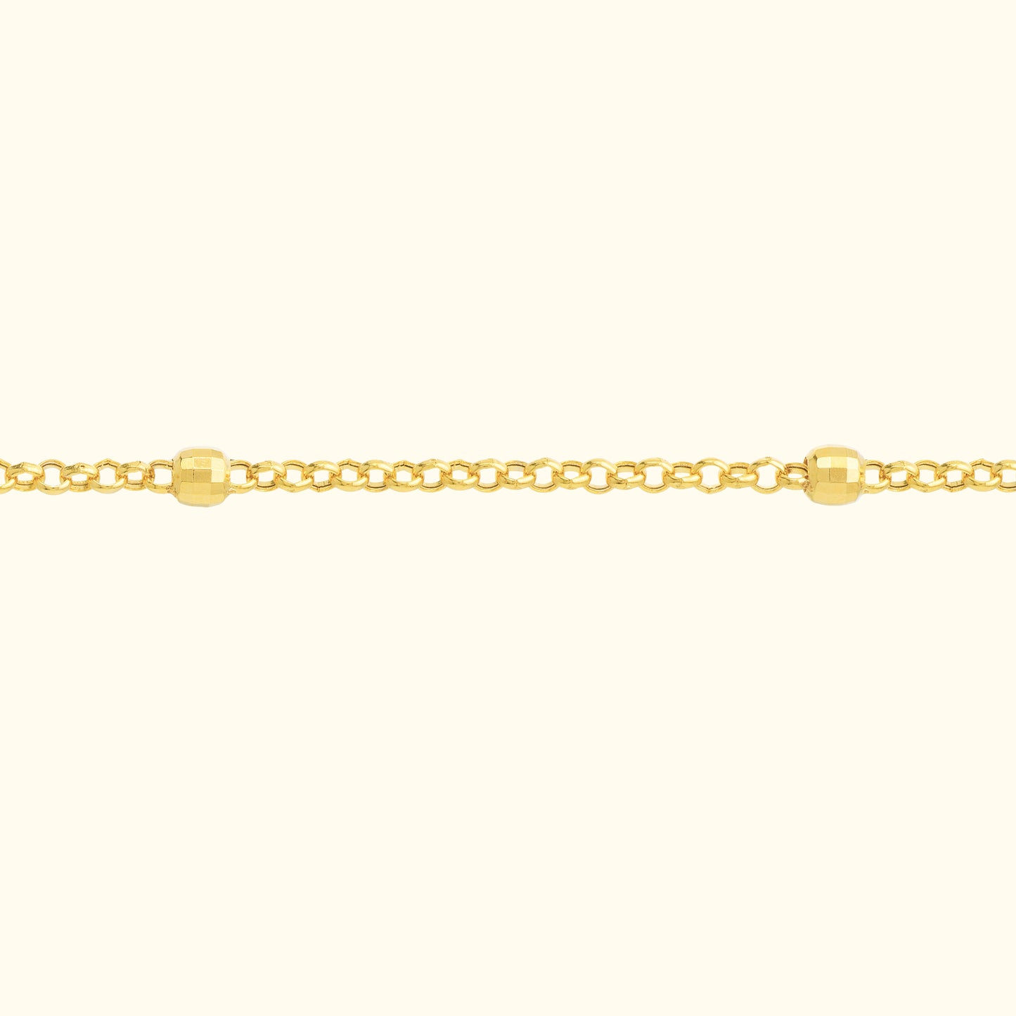 Delicate gold chain bracelet with round beads interspersed along the links.