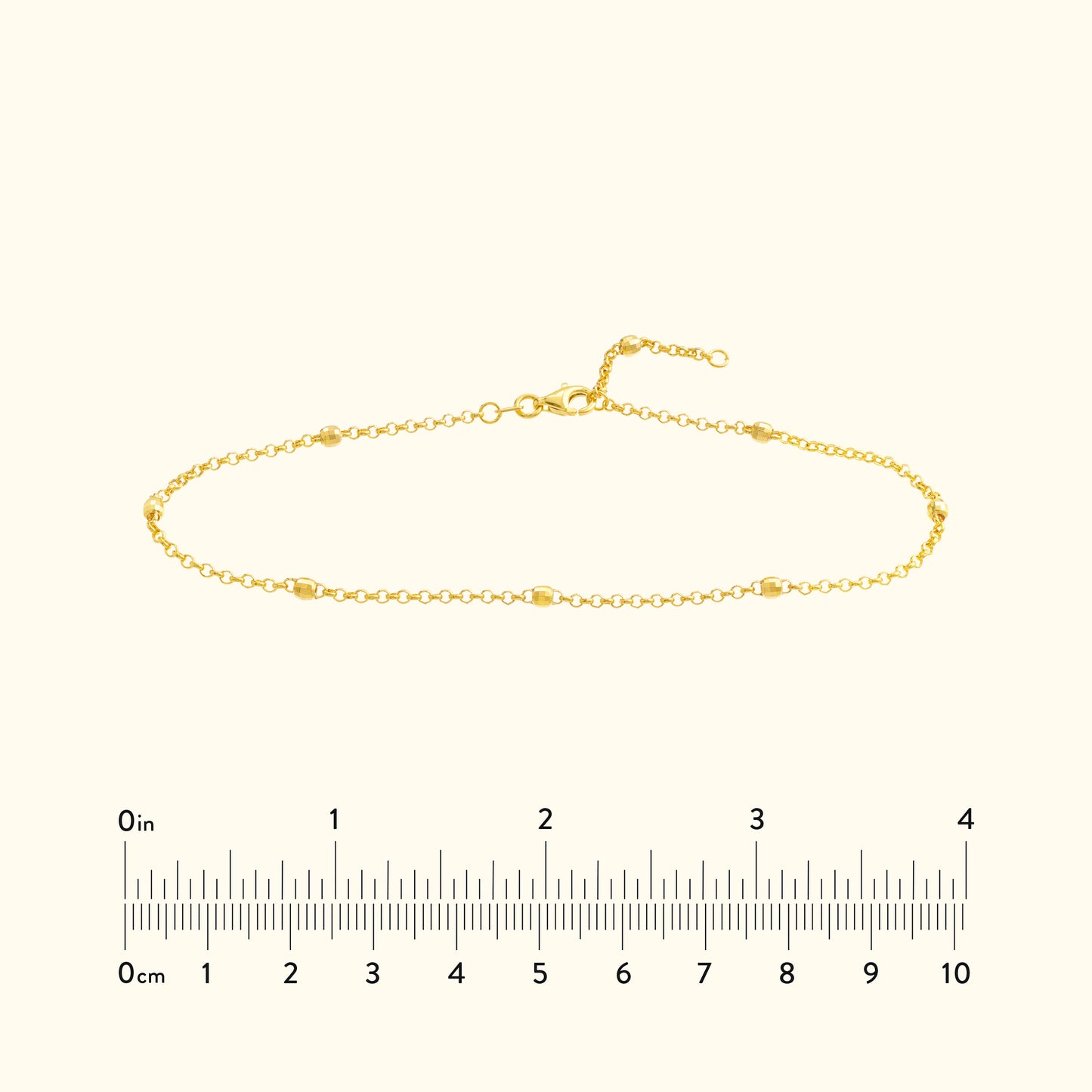 Delicate gold bracelet with small links and a clasp, displayed on a neutral background.