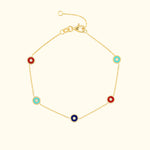 Gold bracelet featuring alternating red, blue, and turquoise circular accents.