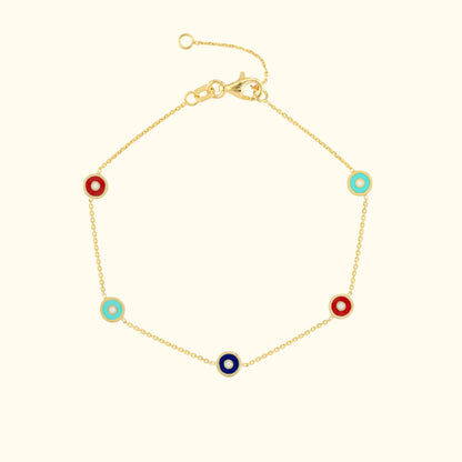 Gold bracelet featuring alternating red, blue, and turquoise circular accents.