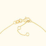 Close-up of a gold chain bracelet with a lobster clasp and adjustable links.