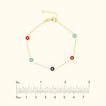 Gold bracelet featuring colorful round charms in red, blue, and turquoise.