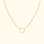Gold chain necklace featuring a circular pendant with a small diamond.