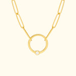 Gold chain necklace featuring a circular pendant with a small diamond.