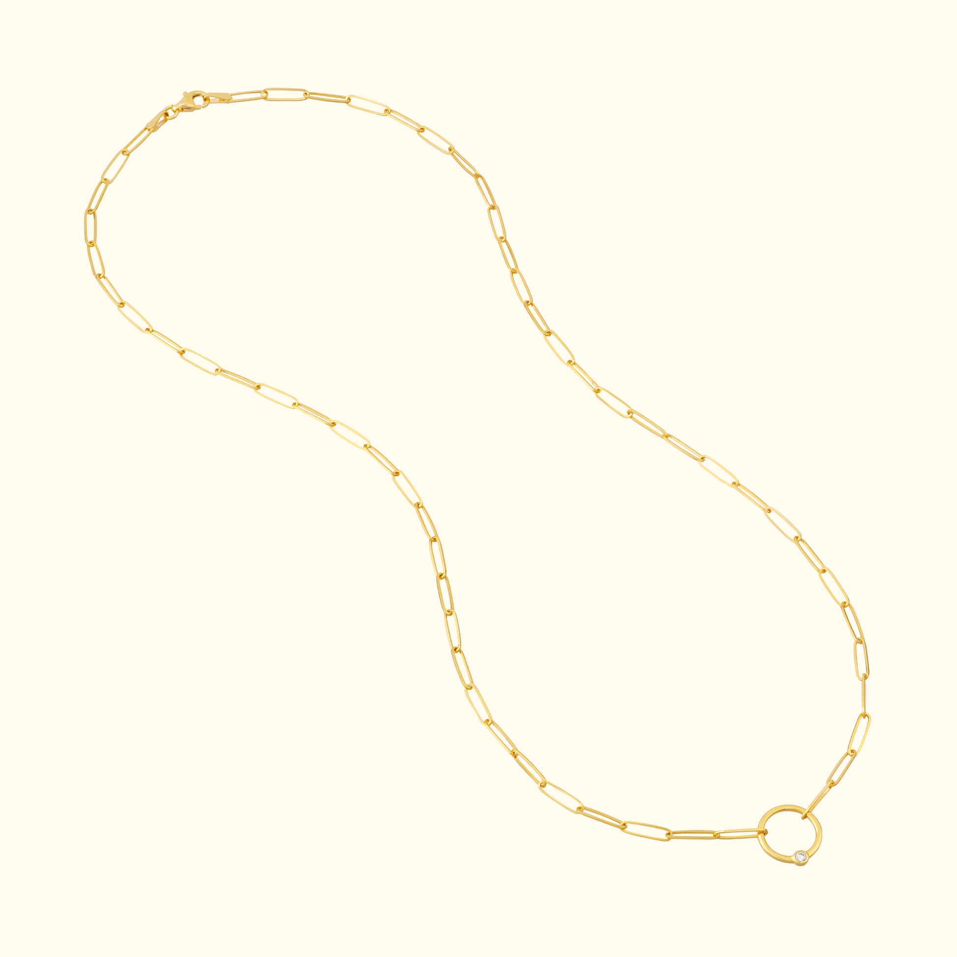 Gold chain necklace with elongated links and a round clasp.